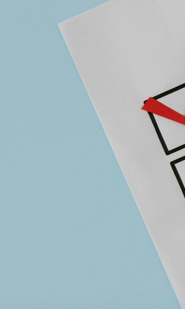 A simple white paper checklist with one red checkmark, ideal for concepts like completion or approval.